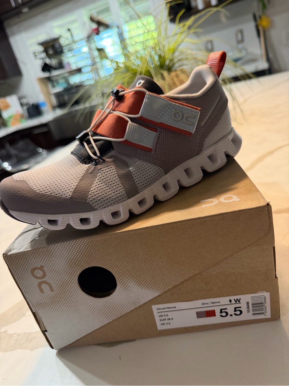 On Running Women's Athletic Shoe in Light Gray with Orange Accents